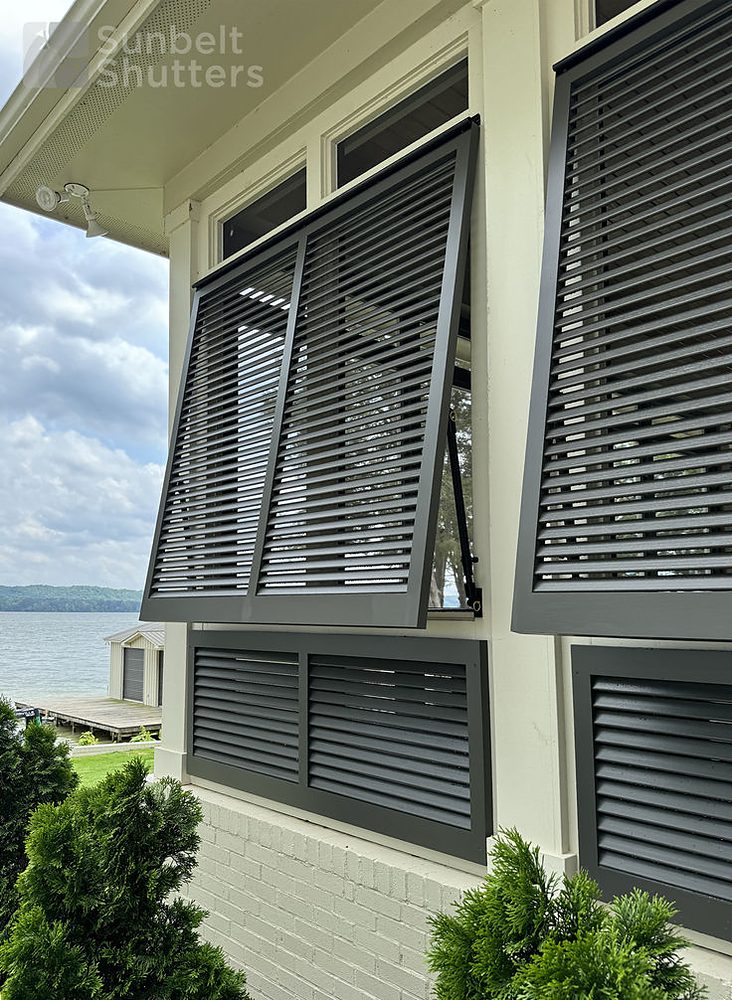 Closed louver Bahama shutters on a lakefront home