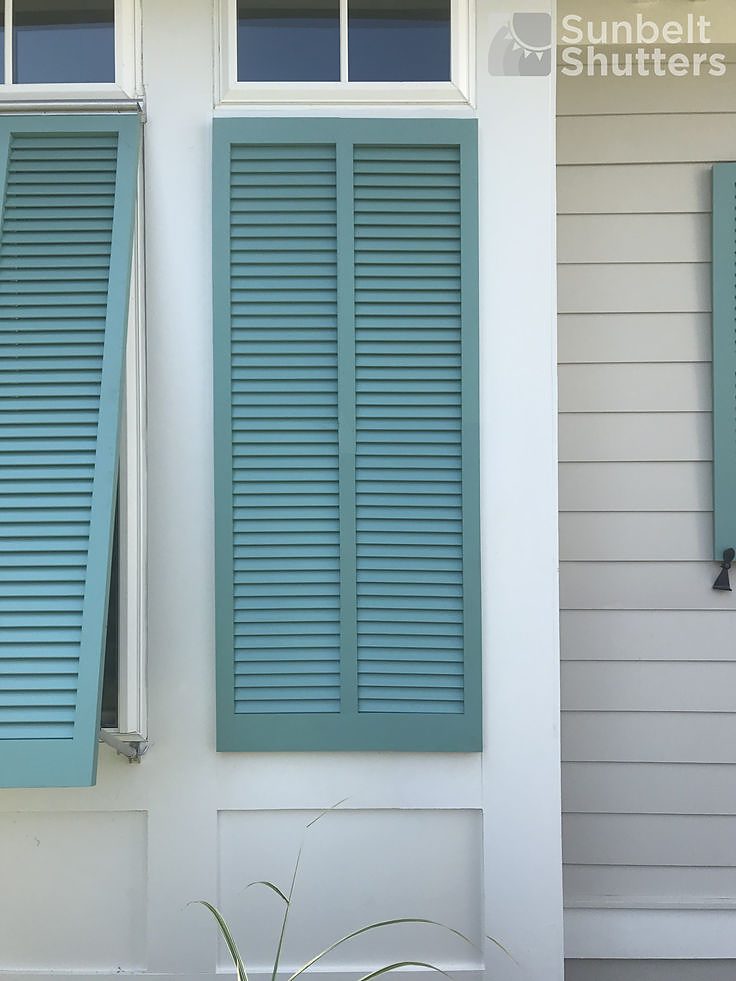 Classic open louver Bahama shutters in seafoam blue