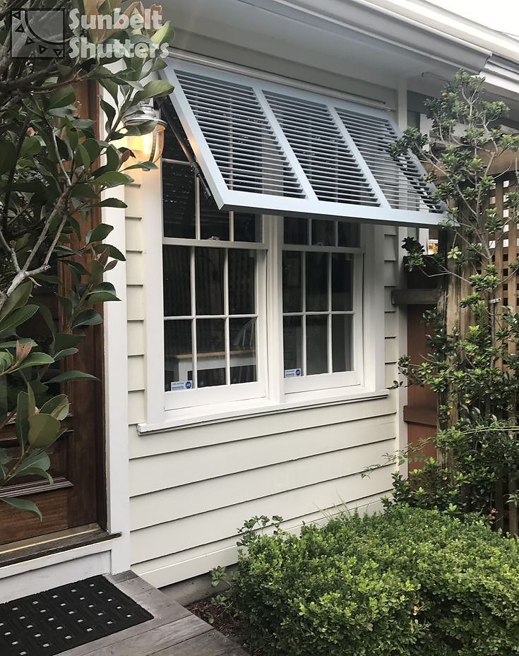 White Bahama shutter shading a cottage window