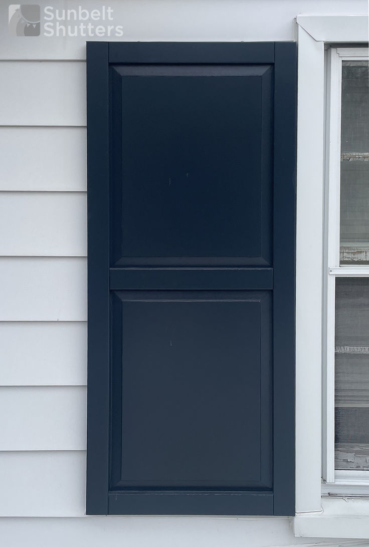 Navy composite shutters on siding