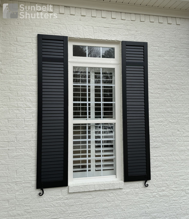 Composite shutters on a white home