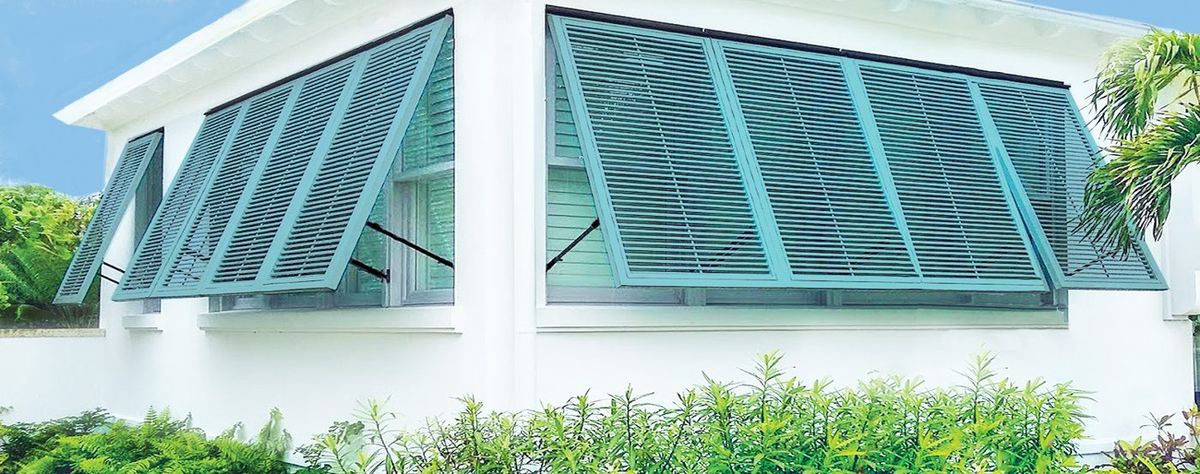 Bahama shutters propped open on a coastal home