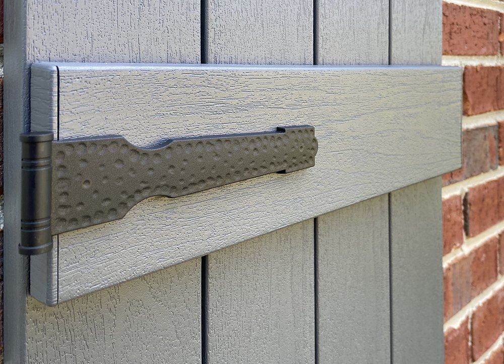 Decorative vinyl strap hinge installed on an exterior shutter