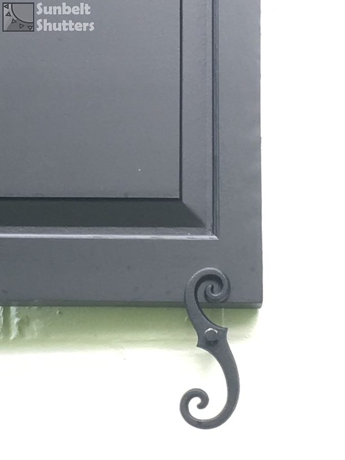 Close up of a raised panel shutter corner with an S-scroll tieback