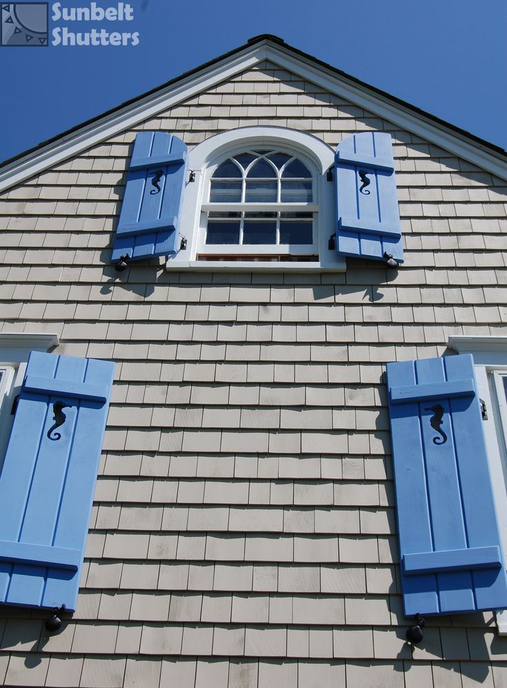 Board and batten wood shutters on a home